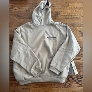Essentials Fear of God hoodie in desert sand.